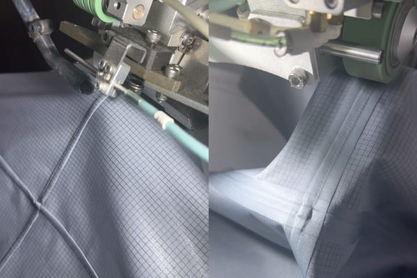 A shot inside a modern, high-tech apparel factory showing a technician operating a precision machine like a laser cutter or seam-sealing station 