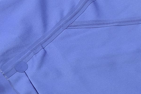 A photo showing the inside of a jacket with clean, precisely applied seam tape along a seam